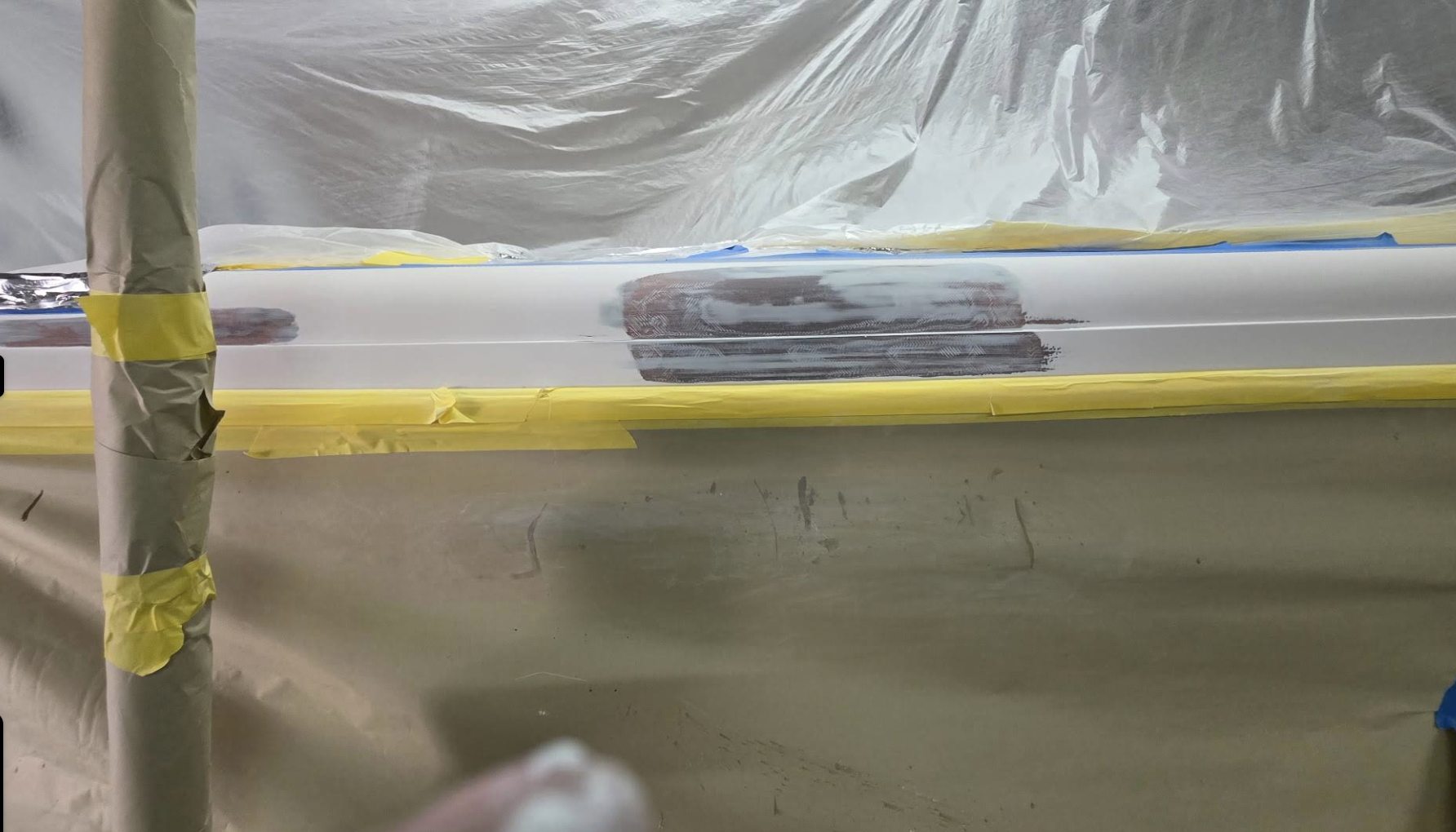 Before: hull and rub-rail masked for repair