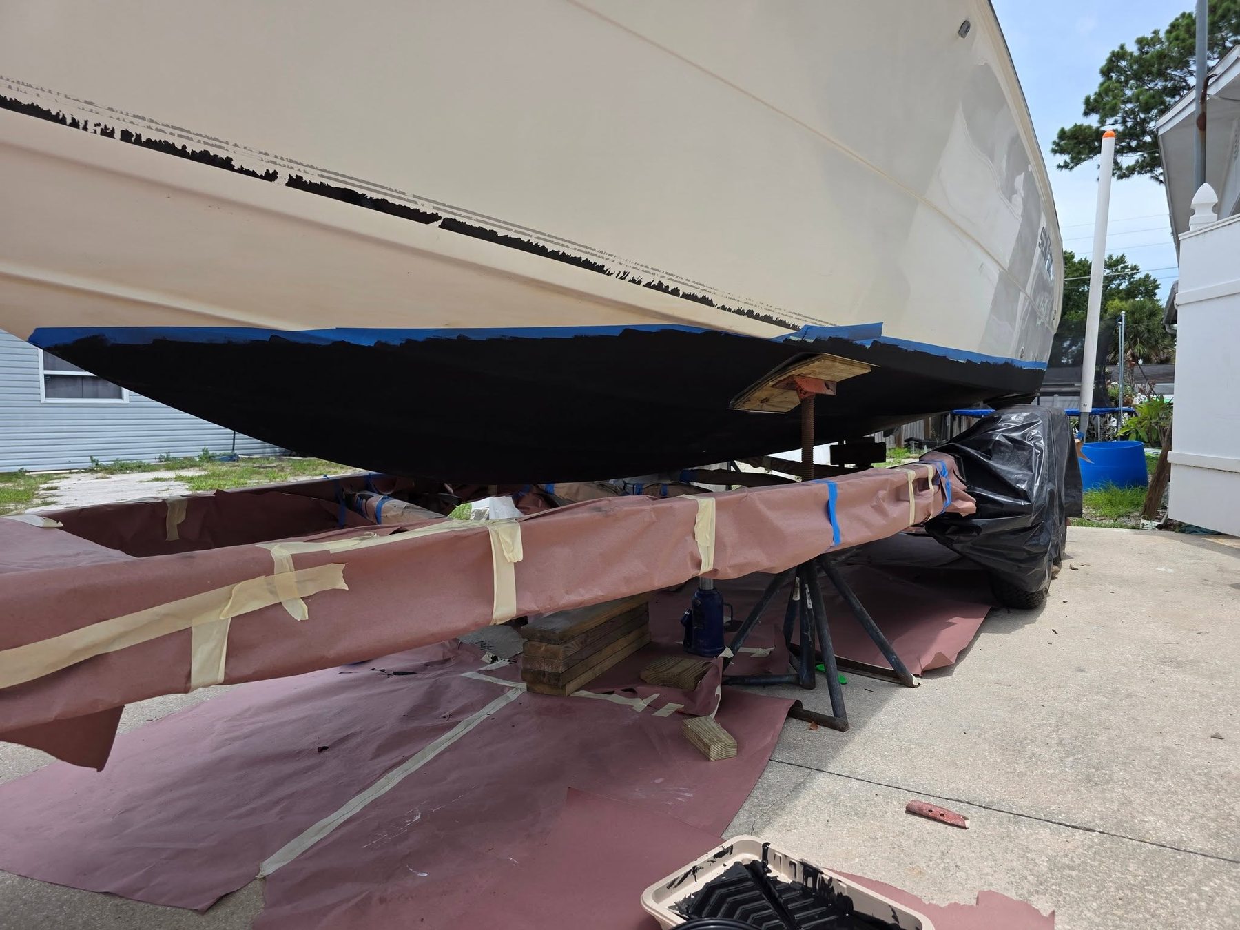 Boat hull taped off for paint and gelcoat work